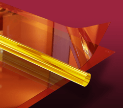 Polyimide tube and Kapton film sheet Close up of polyimide tube on top of a Kapton film sheet